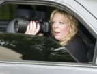 female private investigator with camera